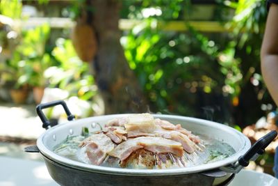 Thailand style bbq grill on a charcoal fire that is located on the bottom with pork, shrimp, squid 