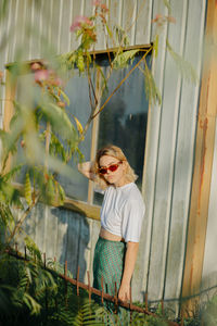 Full length of woman standing by plants