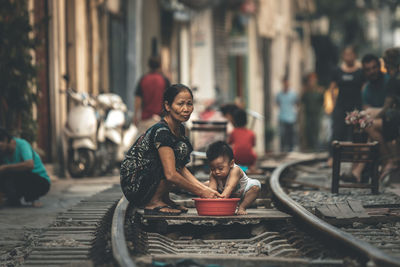 Woman sitting on motorcycle in city