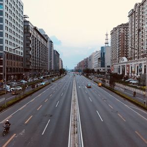 High angle view of cars on road amidst buildings in city against sky 