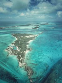 Aerial view of cay in sea against sky
