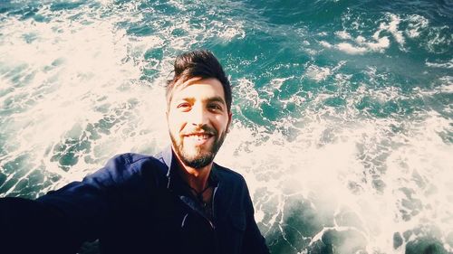 Portrait of smiling young man in sea