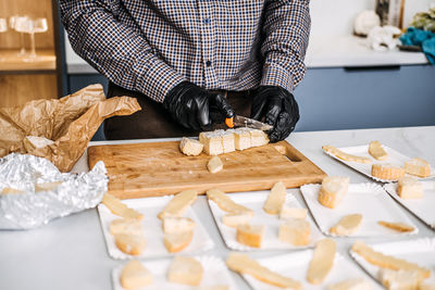 Caterer preparing cheese platters for an event. professional caterer arranges various types food 