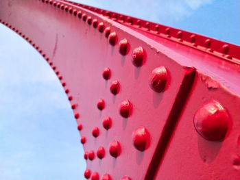 Low angle view of pink metallic structure against sky