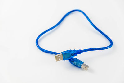 Close-up of blue cable over white background