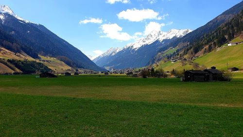 Scenic view of field and mountains against sky