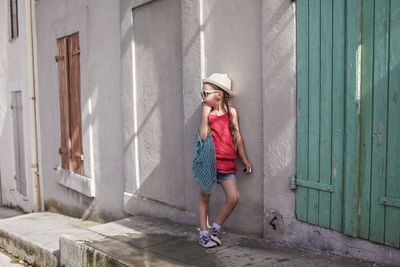 Woman standing against wall