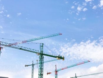 Low angle view of crane against sky