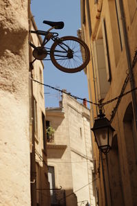 Low angle view of street light against building