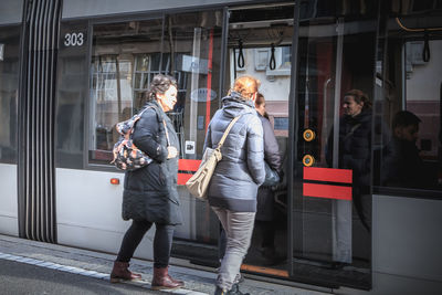 People standing by window in city