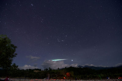Scenic view of star field against sky at night with big streak of meteor