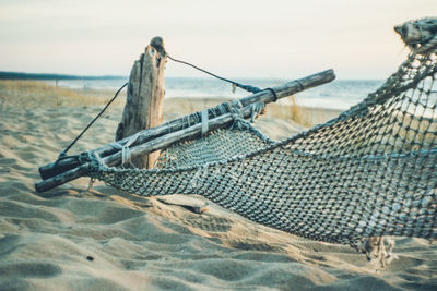 Hammock on beach against sky