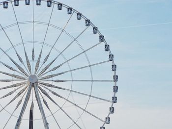 Low angle view of ferris wheel against sky