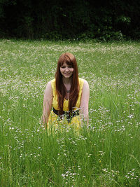 Portrait of smiling young woman on field