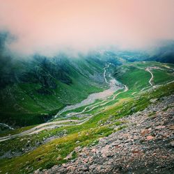 Scenic view of field against cloudy sky