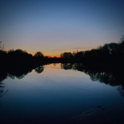 Reflection of trees in calm lake