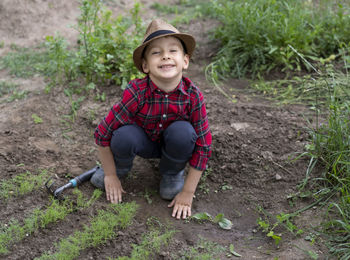 Portrait of boy standing on field