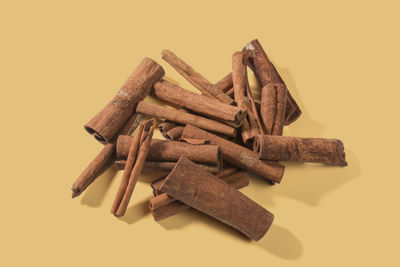 Aromatic dry cinnamon sticks on color background, top view