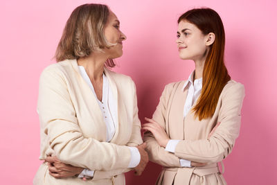 Side view of young woman against gray background