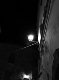 Low angle view of illuminated lights against sky at night