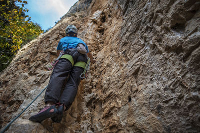 Rear view of person standing on rock