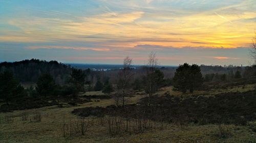 Scenic view of landscape against sky at sunset