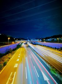 High angle view of light trails on highway at night