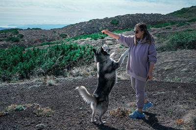 Full length of woman standing on field