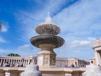 Low angle view of fountain against blue sky