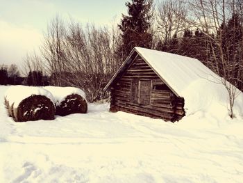 Snow covered house against sky