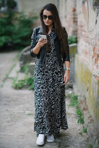 Young woman wearing sunglasses standing outdoors
