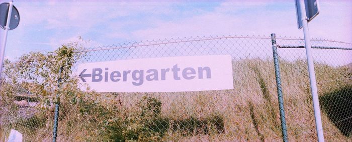 Low angle view of sign board against sky