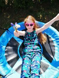 Full length of woman holding sunglasses