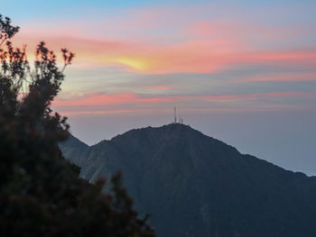 Scenic view of silhouette mountains against sky at sunset