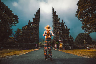 Rear view of woman walking on road