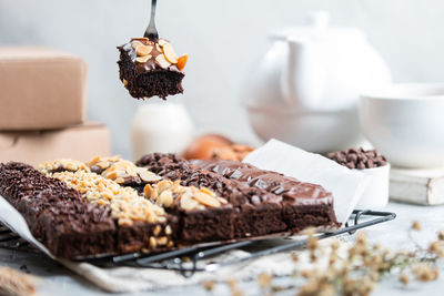 Close-up of chocolate cake on table,
a homemade brownies slice with various topping