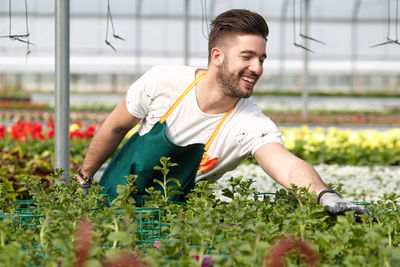 Young man working with flowers