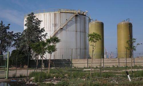 Low angle view of industry against sky