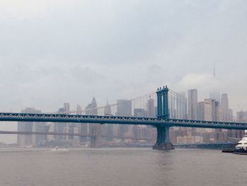 Manhattan bridge 	with skyscrapers of financial district new york city