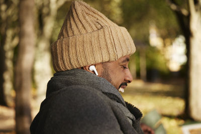 Smiling man sitting on bench