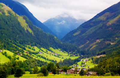 Scenic view of valley and mountains against sky