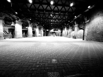 Empty footpath in illuminated building