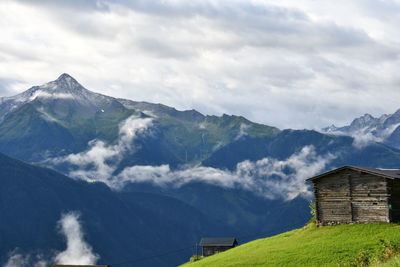 Scenic view of mountains and houses against sky