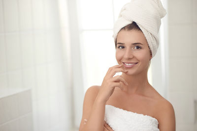 Portrait of smiling young woman in bathroom at home