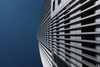 Low angle view of modern building against clear blue sky