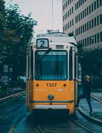 View of railroad tracks by street in city