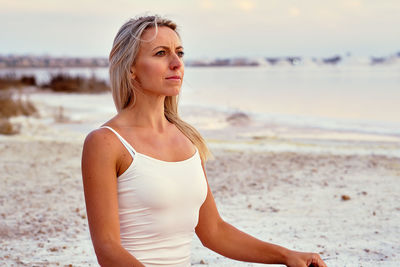 Woman meditating at beach