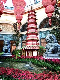 Statue of red flowers against building