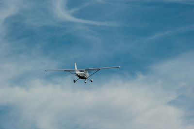 Low angle view of airplane flying in sky