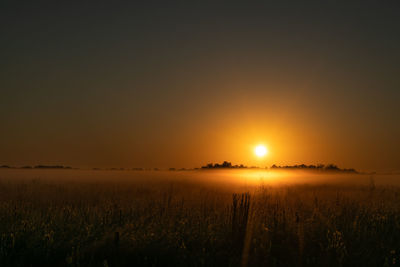 Scenic view of field against sky during sunset